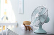 Modern fan on commode in baby room. Space for text
