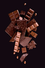 Sticker - Broken chocolate pieces and cocoa powder on wooden background.