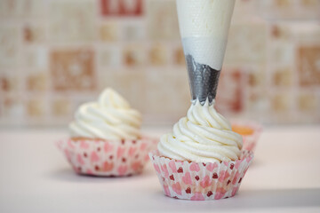 Homemade muffins for Valentine's Day. Photo 2: decorating with cream from a pastry bag.