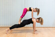 © Jordi Mora - mother, yoga and pilates instructor, and daughter, Caucasian, do plank exercises