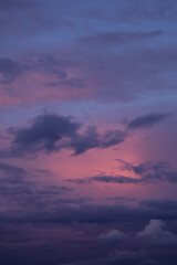 Wall Mural - Sunrise, sunset pink violet blue sky with dark storm clouds background texture