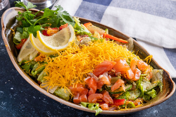 Wall Mural - Salmon salad with fresh vegetables and yellow cheese. Closeup