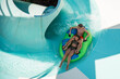 Girl and boy in water Park. Fun on the water. Teen girl and boy having fun in the water slider . Happy children's vacation outdoor.