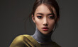 Beautiful Asian woman in a green shawl. Beauty of mysterious Chinese girl with flowing hair. Fashion, clothing and cosmetics
