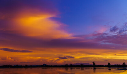 Wall Mural - dusk sky with colorful sunset on sundown in the evening over lake landscape