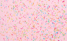 Rainbow Sprinkles On Pink Background