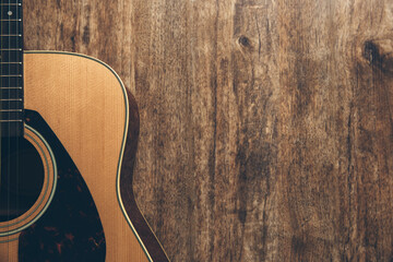 Wall Mural - A guitar on a wooden background.
