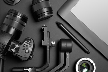 Wall Mural - camera and video production equipment on black background, flat lay