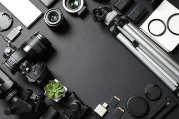 Wall Mural - flat lay composition with camera and video production equipment on black background. space for text