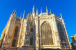 Famous church Milan Cathedral Duomo di Milano with Gothic spires and white marble statues. Top tourist attraction on piazza in Milan Lombardia Italy. Wide angle view of old Gothic architecture and art
