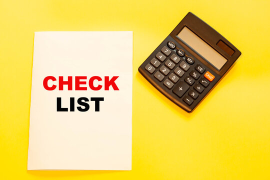 Checklist on paper with a calculator for calculations.