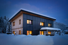 Heat Energy Self-sufficient Single-family House In The Snow-covered Winter With Solar Thermal Collectors On The Facade