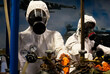 People in protective suits in the laboratory for the production of chemical and biological weapons.