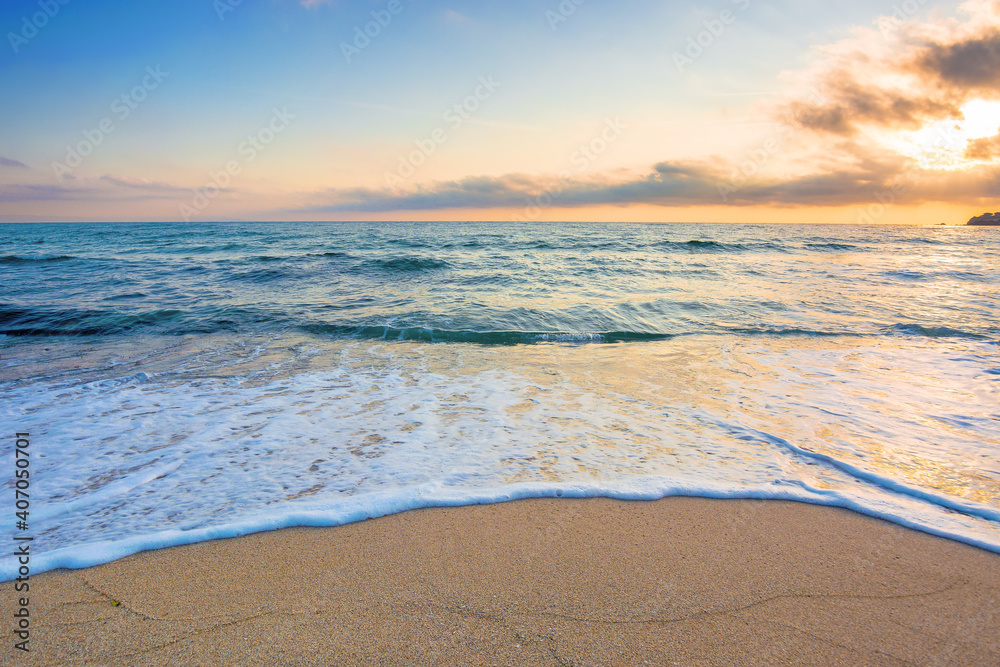 summer vacation at the seaside. beautiful seascape at sunrise. calm waves wash the golden sandy beach. fluffy clouds on the sky - obrazy, fototapety, plakaty 