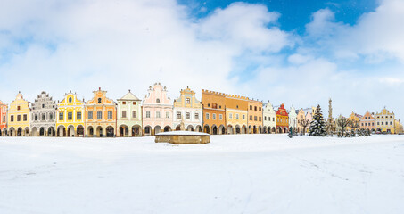 Wall Mural - Main square of Telc with its famous 16th-century colorful houses, a UNESCO World Heritage Site since 1992, on a winter day with falling snow.