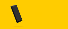 Black Phone On Yellow Background, Panoramic Image