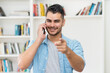 © Daniel Ernst - Handsome latin american hipster man talking at mobile phone