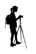 Backlit silhouette of a female photographer hiking and isolated on a white background for composites. She is holding a camera and posing as a journalist or a hobbyist