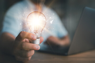 Poster - Innovation. Hands holding light bulb for Concept new idea concept with innovation and inspiration, innovative technology in science and communication concept,