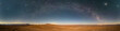 An amazing panoramic view of the Milky Way above Atacama Desert vast sand fields. An awe night sky view with our galaxy arm creating an arch in between the stars. An idyllic and motivational scenery.