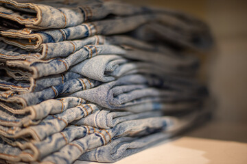 Sticker - Selective focus on denim jeans packed on rack