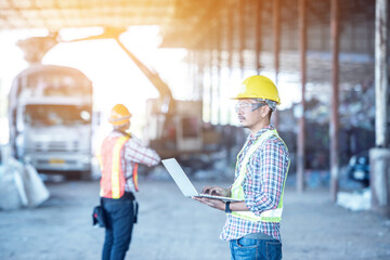 Wall Mural - Professional Industrial Mechanical Engineer with Factory Worker while Using Laptop Computer at Metal lathe industrial manufacturing factory. Engineer Operating are working on projects in  factory