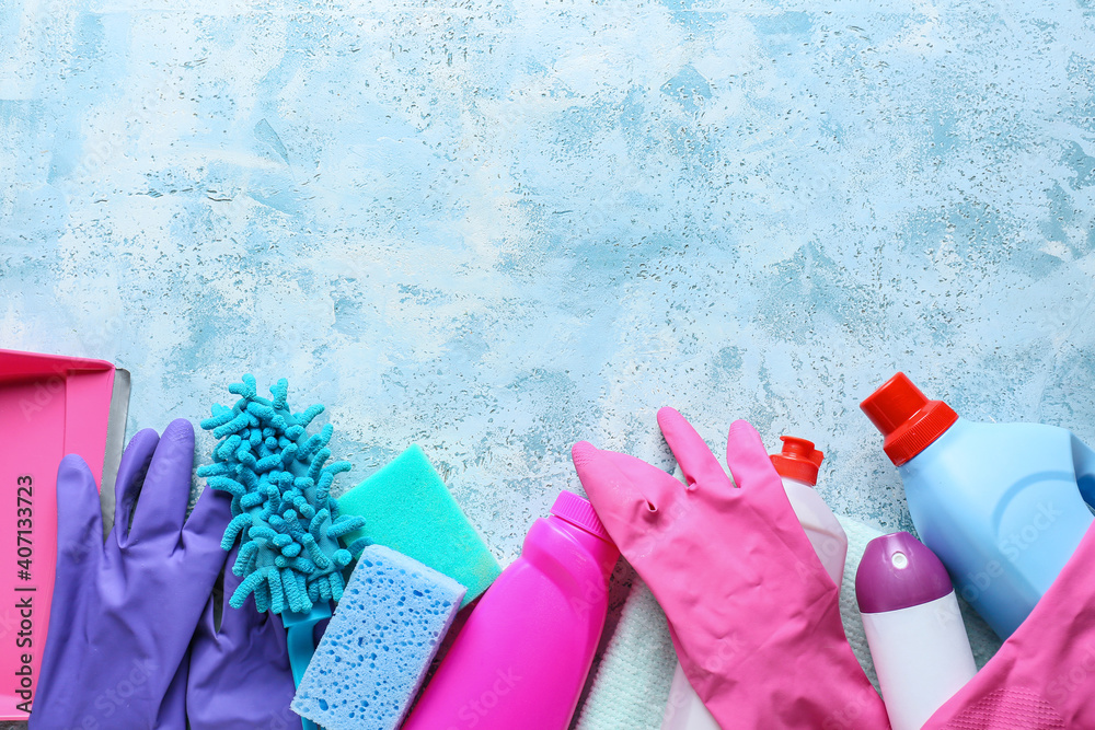 Set of cleaning supplies on color background