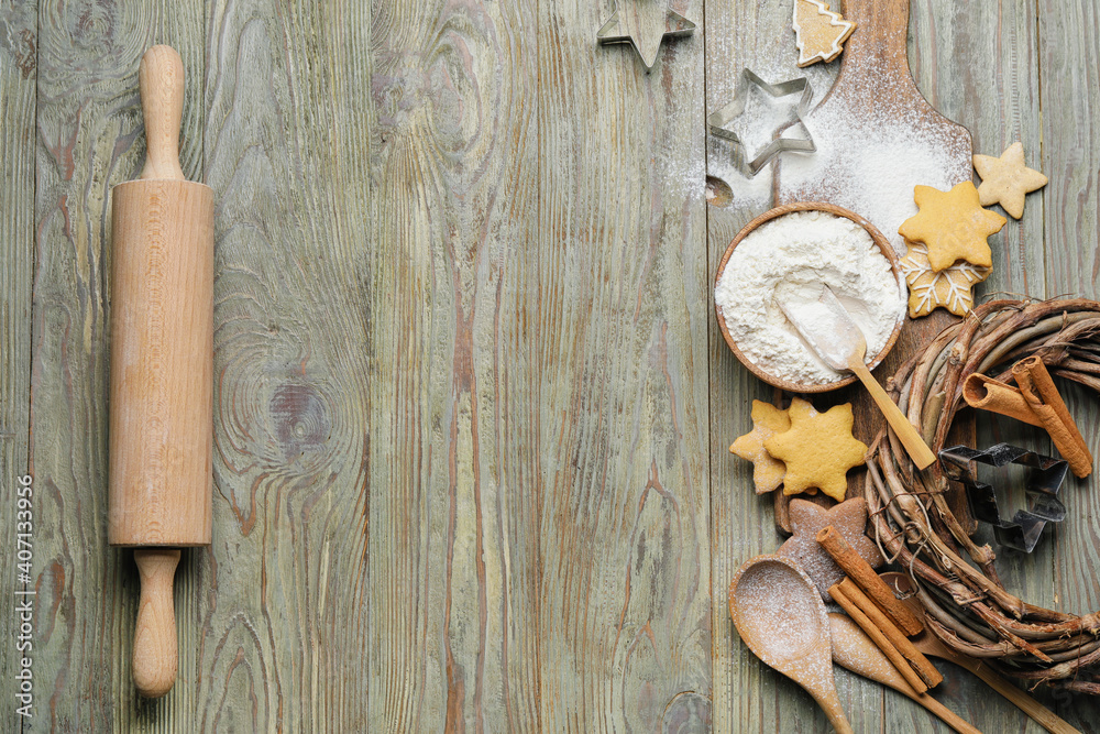 Ingredients, cookies and rolling pin on wooden background