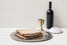 Passover Seder Plate With Matzo, Jewish Cap And Wine On Table