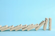 canvas print picture - White domino tiles falling on light blue background. Space for text