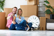 © didesign - Young couple celebrating moving to new home