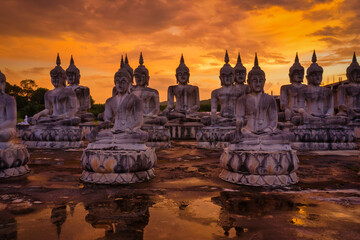 Wall Mural - Many Statue buddha image at sunset in southen of Thailand