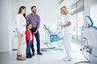 © didesign - Family visits dentist in dental office