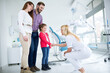 © didesign - Family visits dentist in dental office