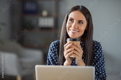 Photo of charming dreamy young business woman sit office coffee break work laptop look window in office workplace © deagreez