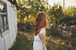 © SHOTPRIME STUDIO - happy traveler in countryside near buildings outdoors trees back view