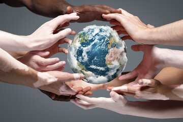 Hands holding, touching planet Earth, close up on grey background. Environment save, taking care of nature and ecology, supporting hands concept. Globe woldwide protection, traveling. Beauty.