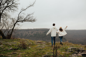 Wall Mural - Nice lovely cute couple having fun on vacation at the mountain. Holidays, love, relationship concept. Follow me.