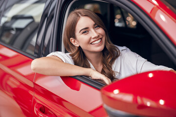 Happy woman sitting in new automobile