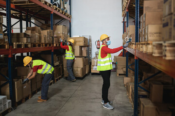 Wall Mural - Industrial worker people inside warehouse wearing safety masks for coronavirus prevention - Focus on man