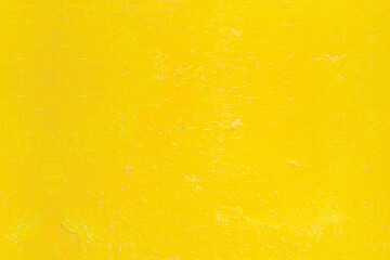 Wall Mural - Background with a surface painted with bright yellow paint. Cracked old paint on a wooden surface