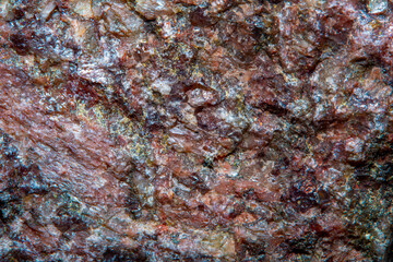 Wall Mural - Background with the surface of a piece of red granite interspersed with quartz in soft focus under high magnification