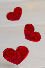 Wall Mural - Different red hearts in levitation on light background for Saint Valentines day celebration or love concept