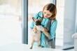 © Serhii - Beautiful young female veterinarian examining dog in clinic
