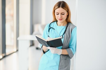 Beautiful smiling doctor woman in medical gown