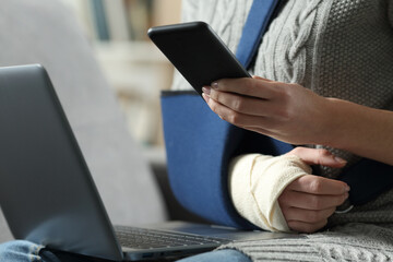 Disabled woman with broken arm using smartphone