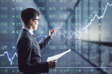 Wall Mural - Businessman with papers in hand working in office with virtual financial chart, investment and trading concept