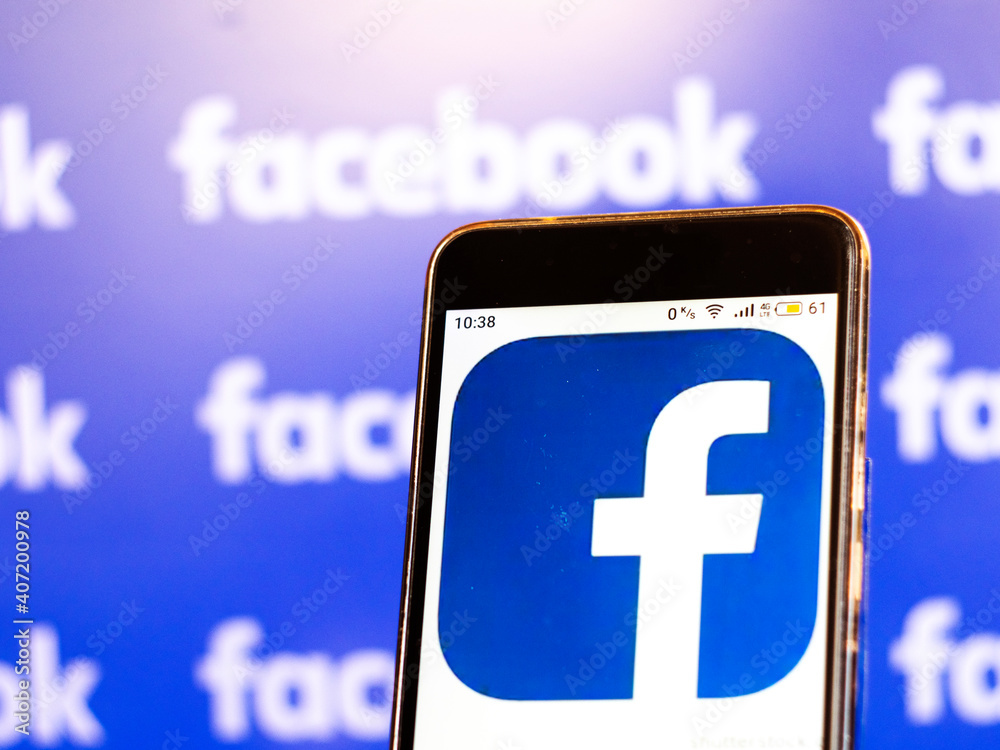 Facebook logo seen displayed on smart phone Stock Photo | Adobe Stock
