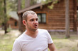 © Татьяна - Portrait of young Caucasian man in plain t-shirt outdoors. Rest, vacation in the country concept