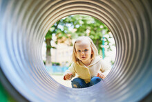 Adorable Toddler Girl Having Fun On Playground